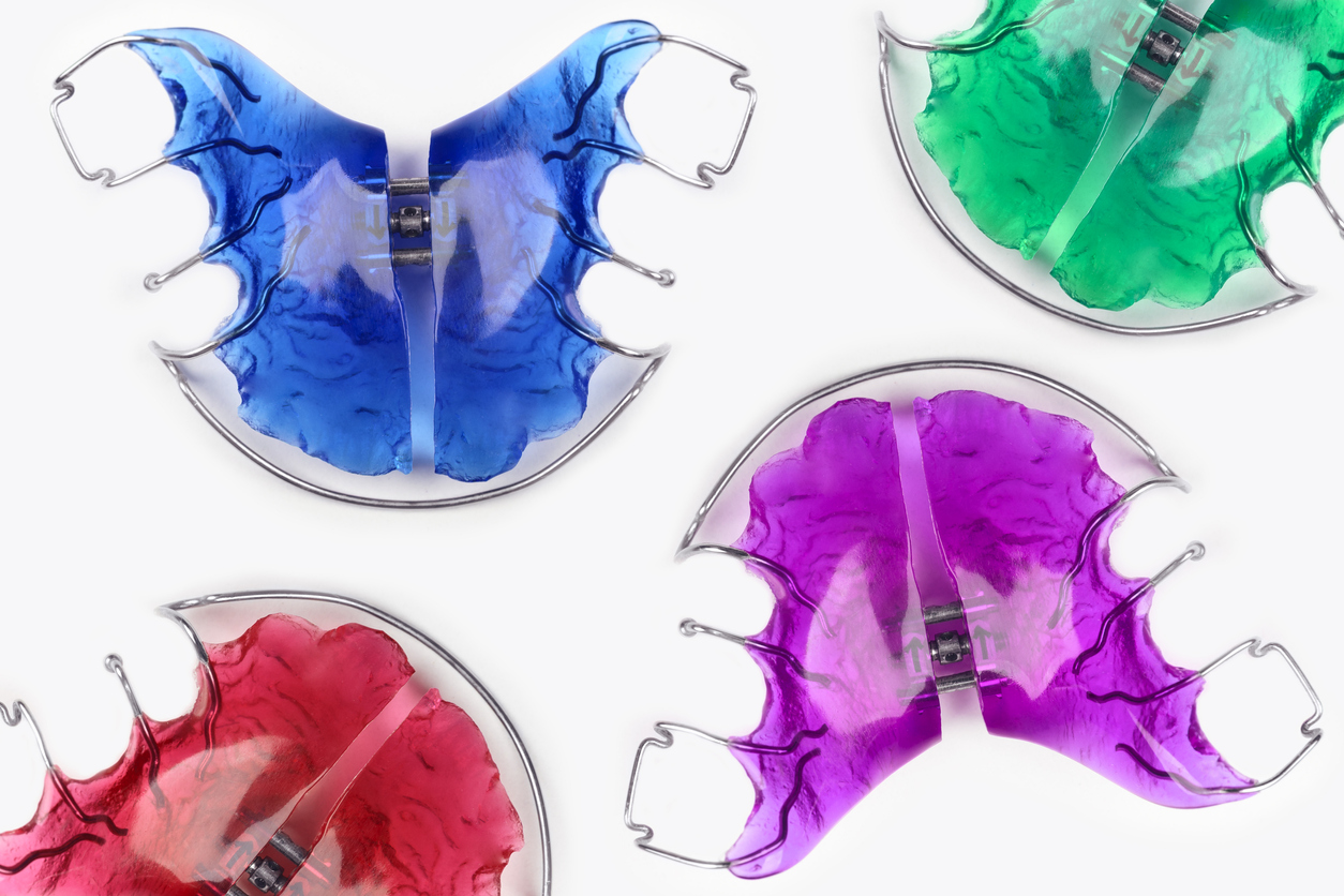 Close-up of children's orthodontic appliances in bright, fun colours