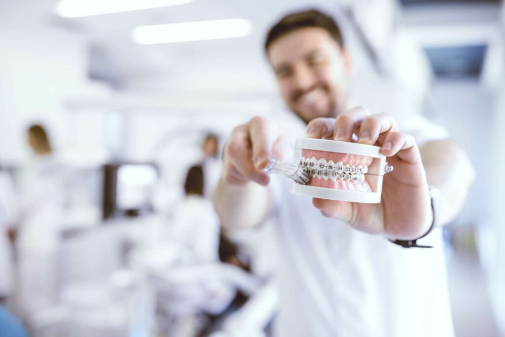 dentist brushing fake teeth